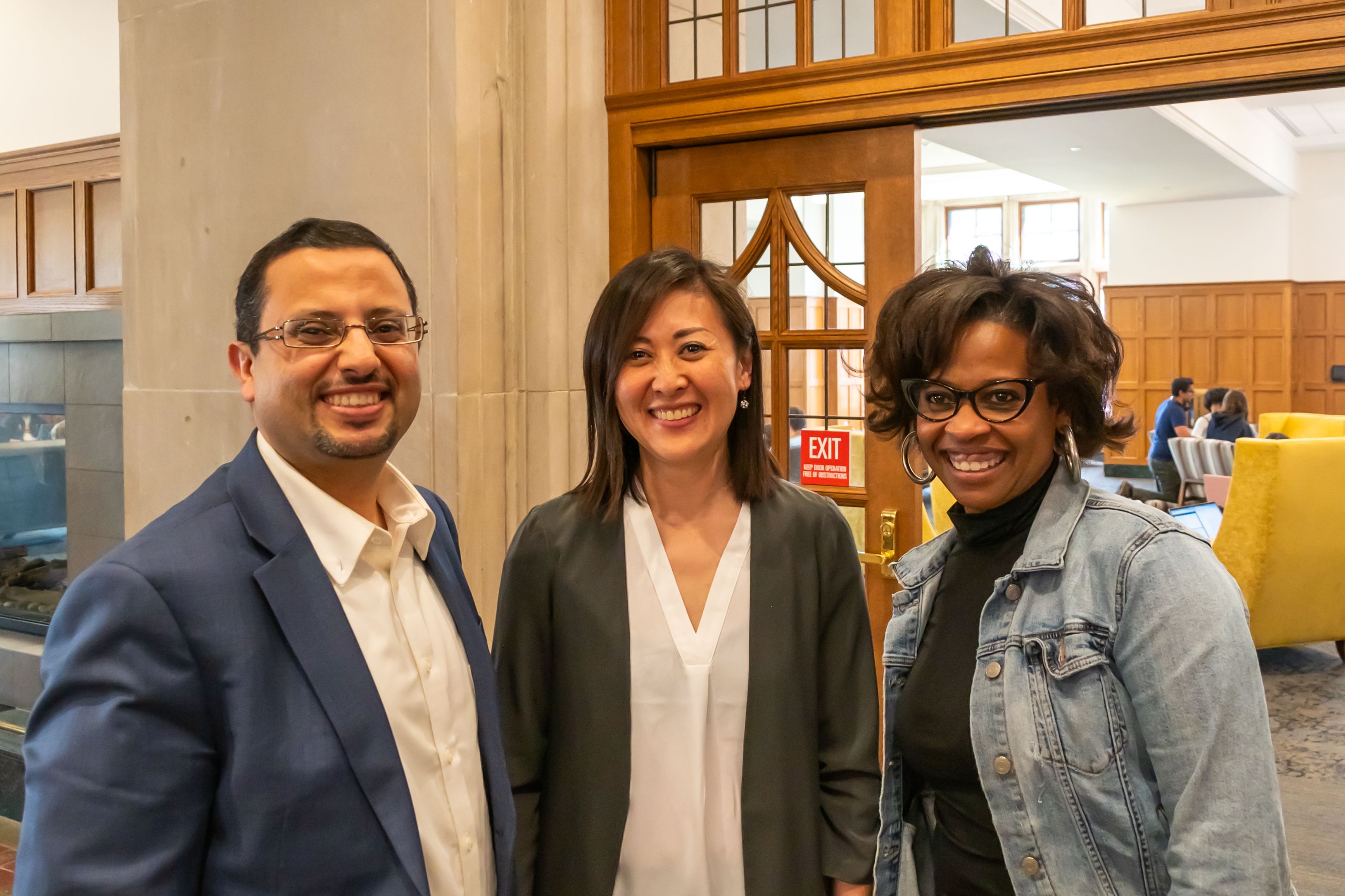 Three people standing together and smiling