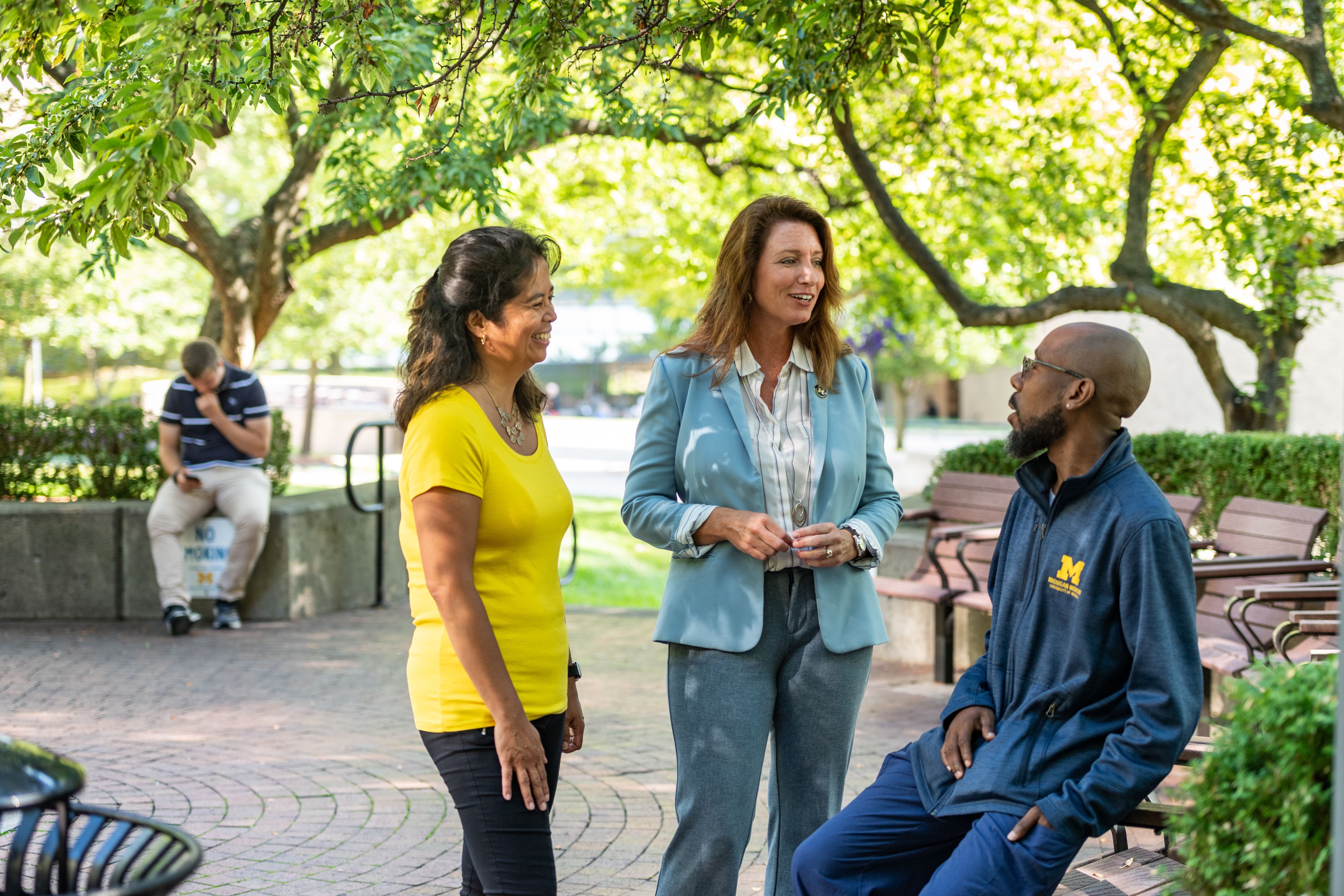 A group of staff having a conversation on a patio at Michigan Medicine