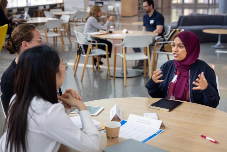 Students having a conversation at a table