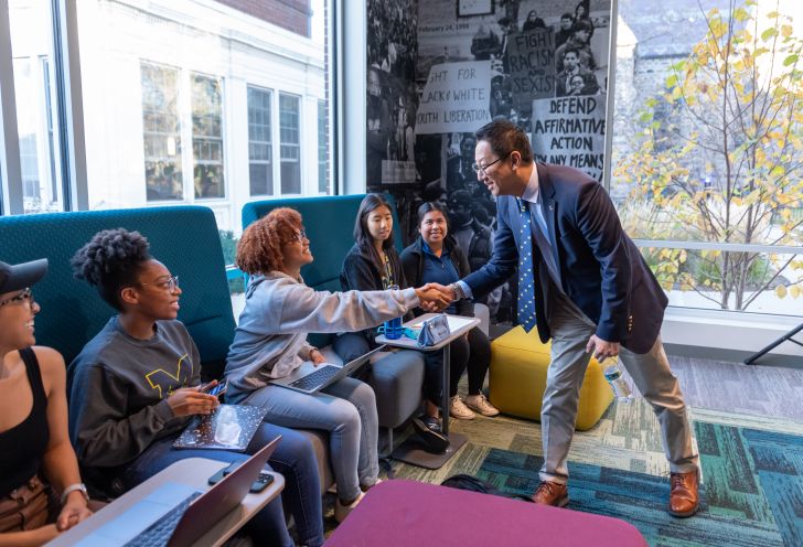 President Ono shaking students' hands