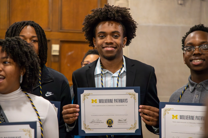 Students holding Wolverine Pathways certificates