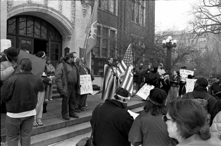 A black and white photo of a protest on the steps of the Michigan Union