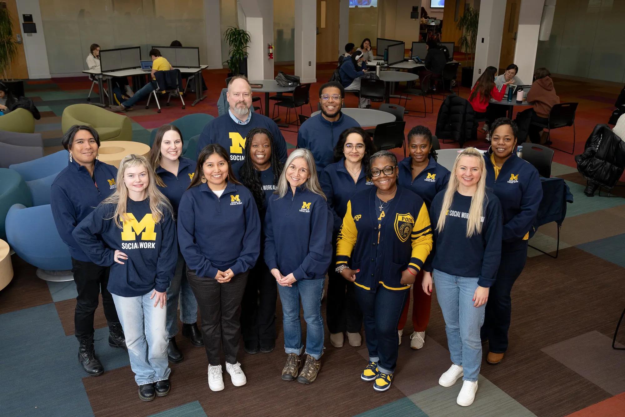 A group photo of people wearing U-M Social Work branded clothing