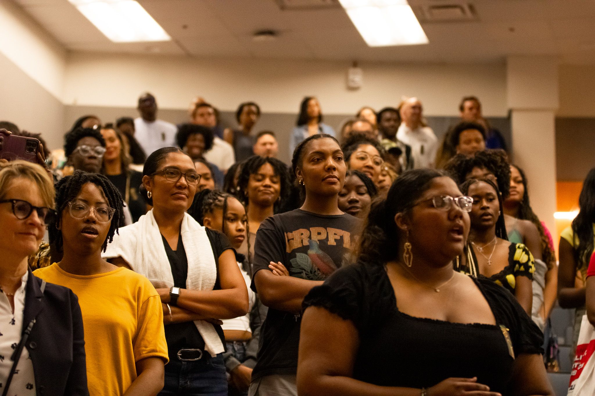 People standing during an event in an auditiorium