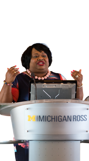 Katrina Wade-Golden speaking at a lectern with the Michigan Ross logo