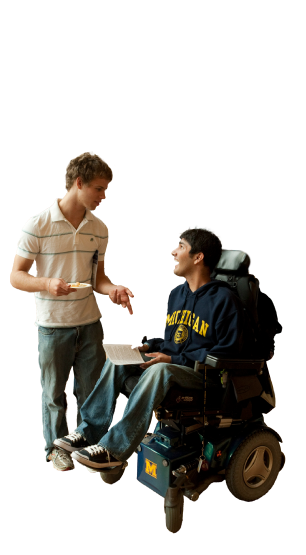 Two people having a conversation. One person is sitting in a wheelchair.